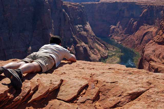 a tourist shooting Horseshoe Bend